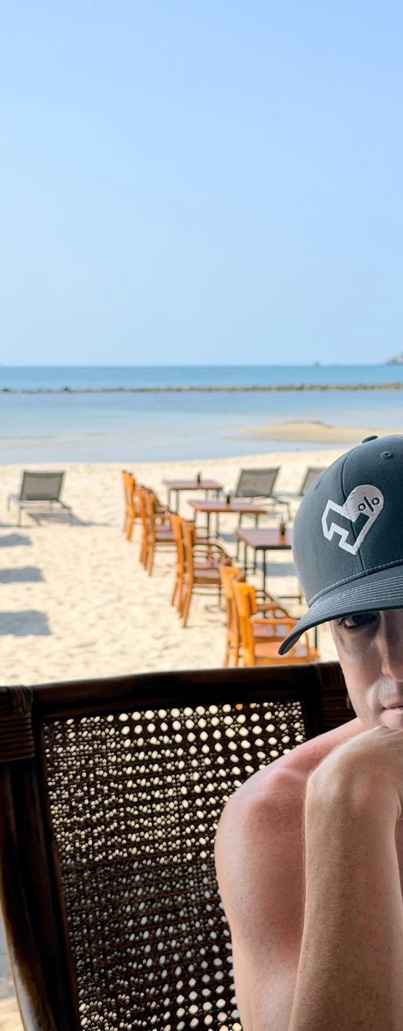 OPH trucker hat at a beachfront restaurant in Thailand